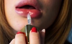 close-up-of-sensual-babe-putting-lipstick-on-her-sexy-lips